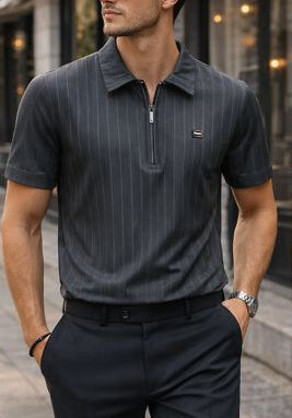 Man wearing a black pinstripe polo shirt and black pants on a city street.